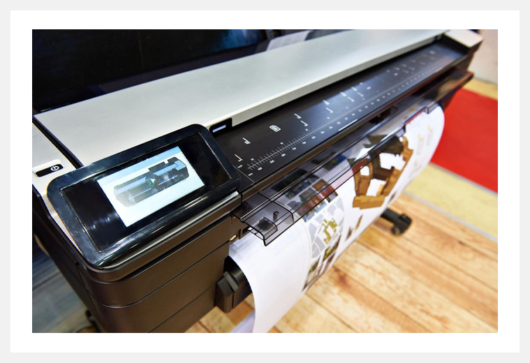 A close up of an inkjet printer on the floor